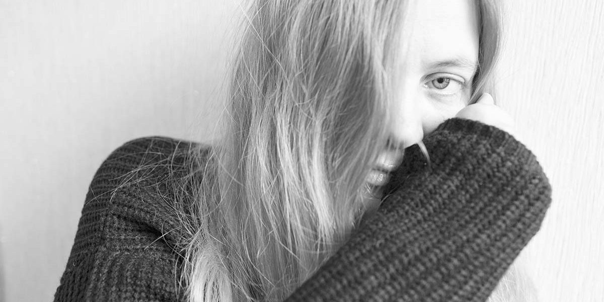 woman wiping her nose with her sleeve displaying meth side effects leading to Parkinson's disease