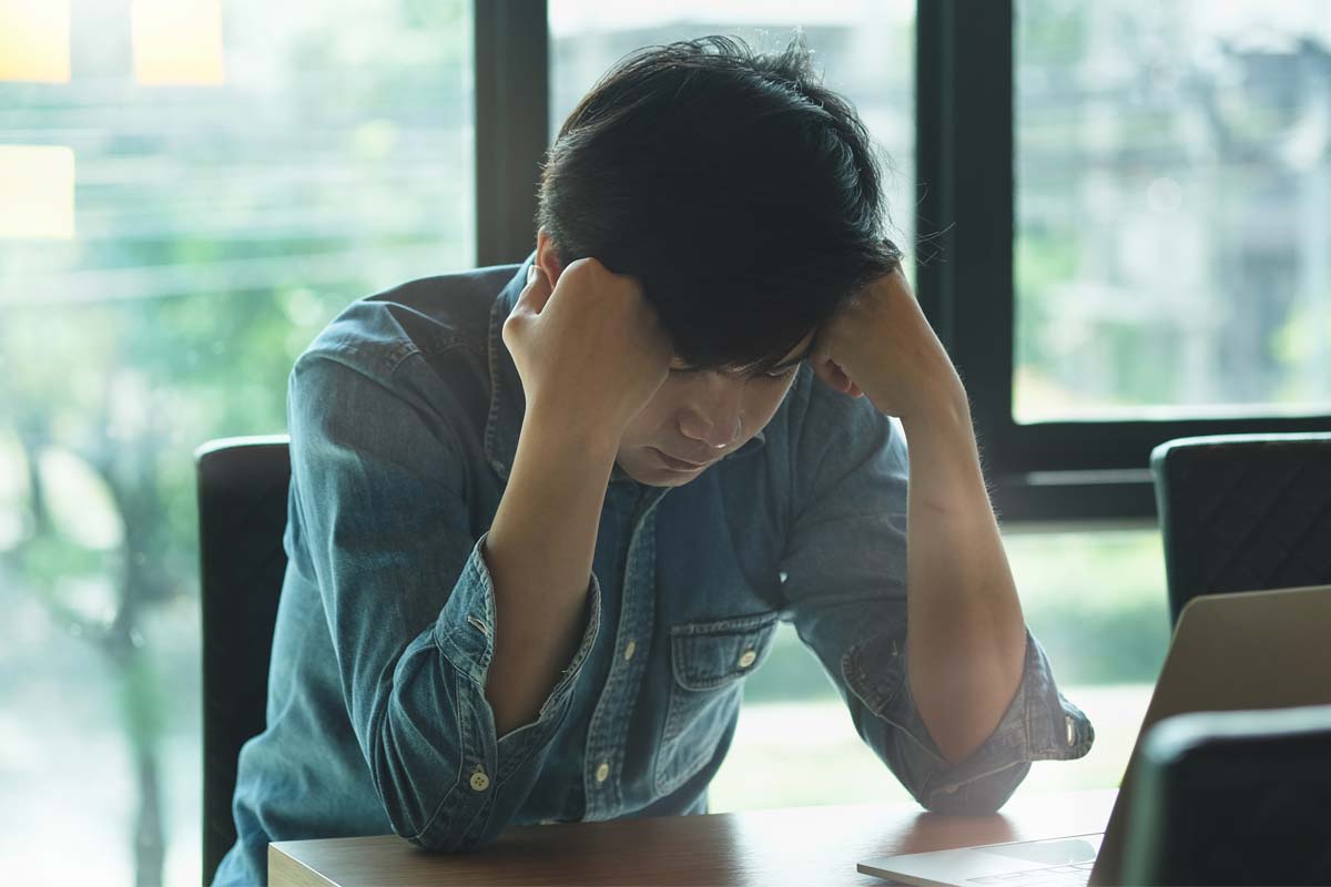man resting on his hands in conference room dealing with drug use by occupation