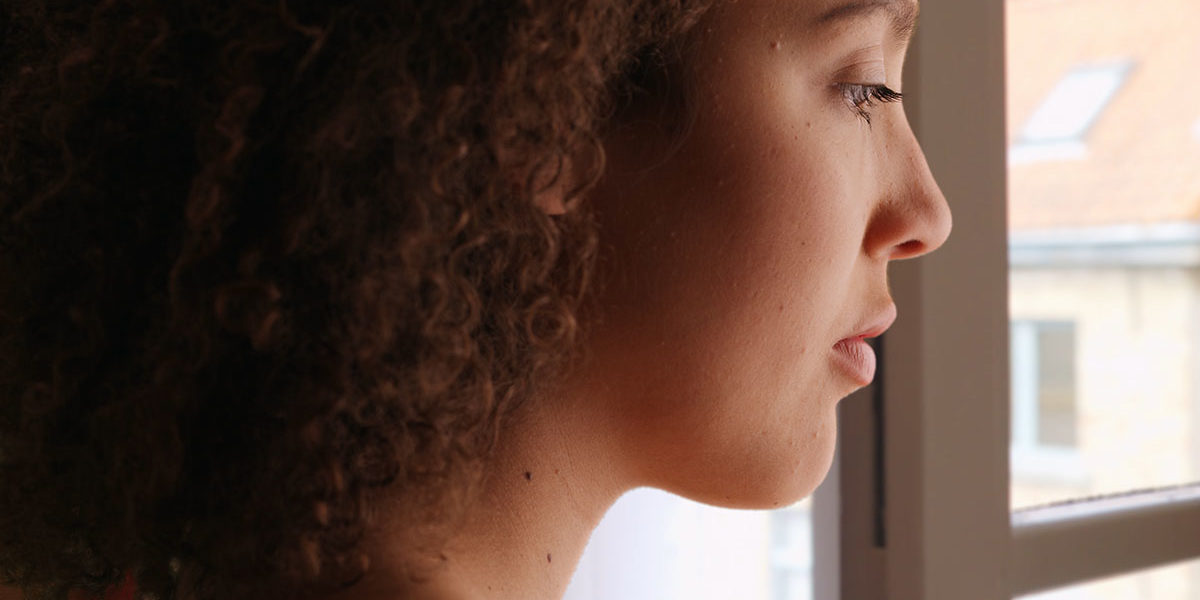 a woman thinking about addiction recovery