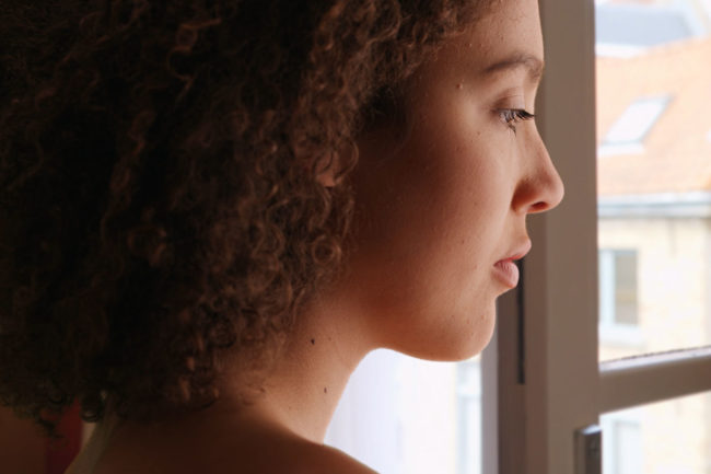 a woman thinking about addiction recovery