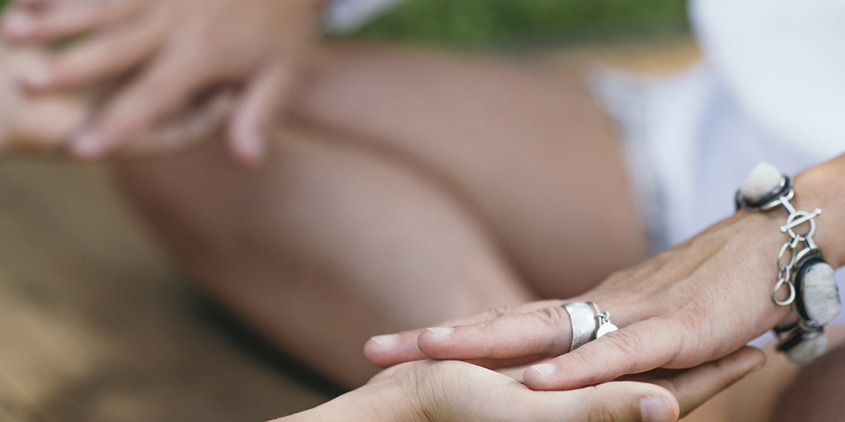 a person meditating with a group leader at a holistic alcohol detox