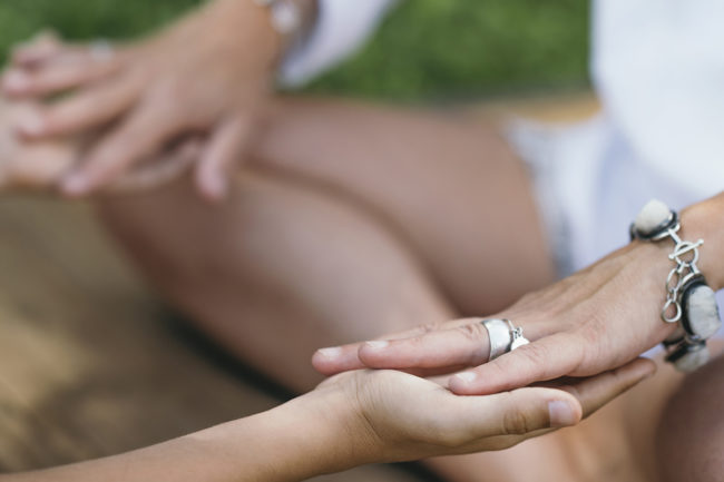 a person meditating with a group leader at a holistic alcohol detox