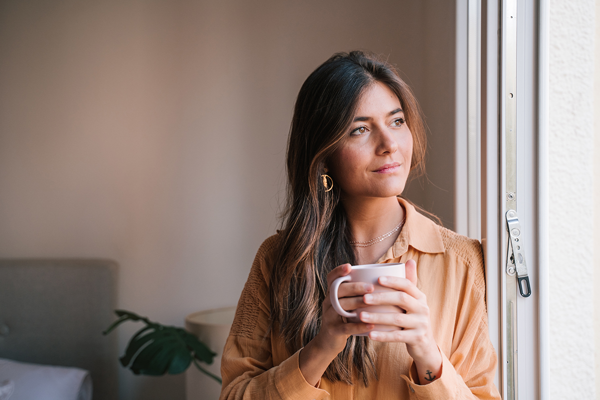 a woman drinking tea thinking about her friend in Vicodin detox