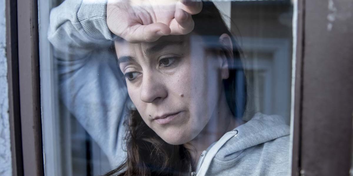 uncomfortable woman looking out window wondering how heroin addiction starts