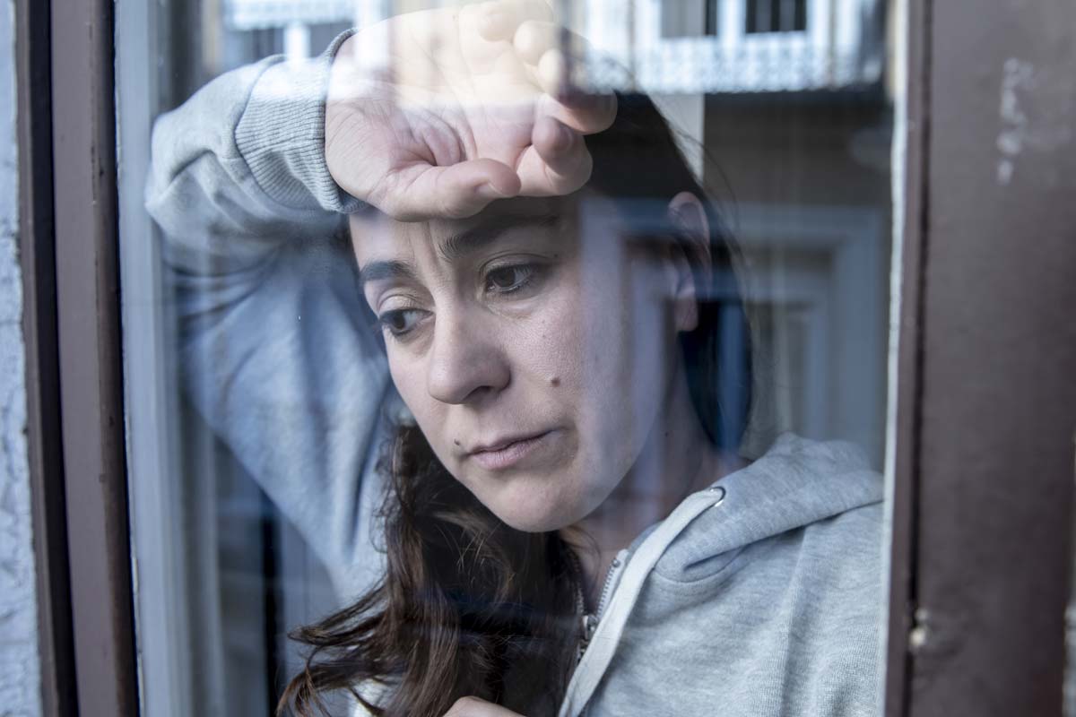 uncomfortable woman looking out window wondering how heroin addiction starts