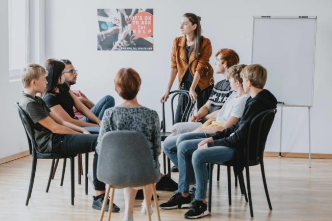 a group of people in an alcohol detox program talking about what qualities make it successful