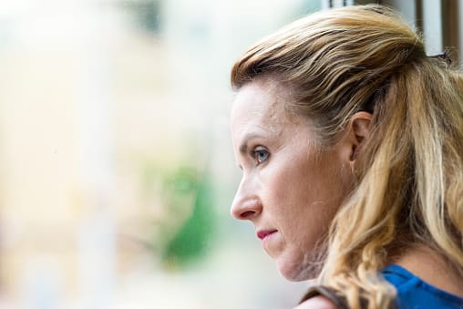 Concerned business woman contemplating an executive rehab for her drug problem.