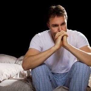 Man looking sad with hands to face feels like he is addicted to codeine.