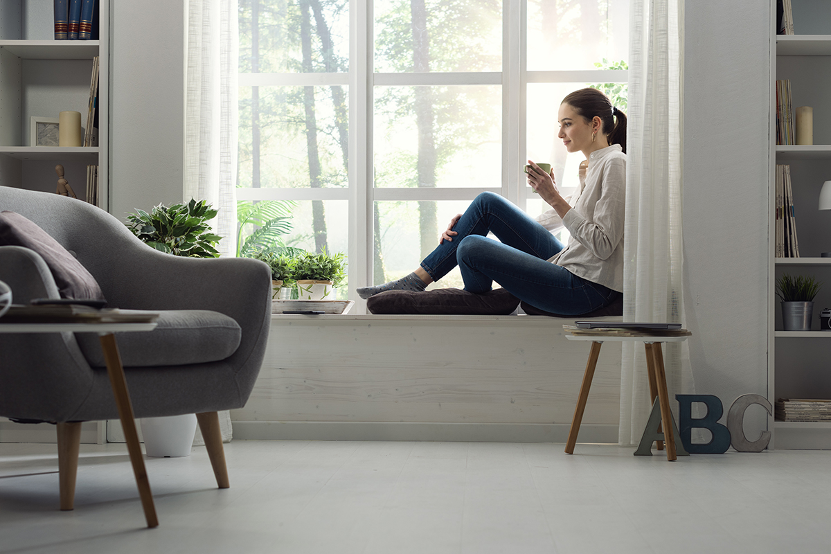 a woman drinking tea as she rests knowing her friend is not going to detox at home