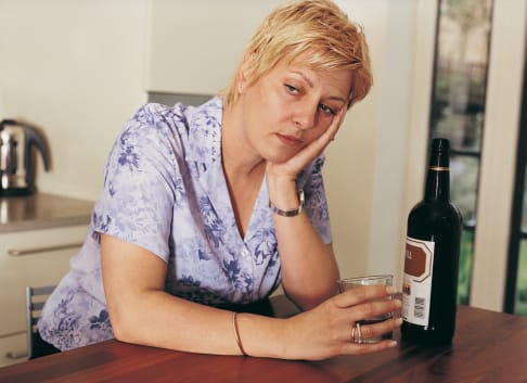 This drunk, sad woman already knows some of the long term effects of alcohol.