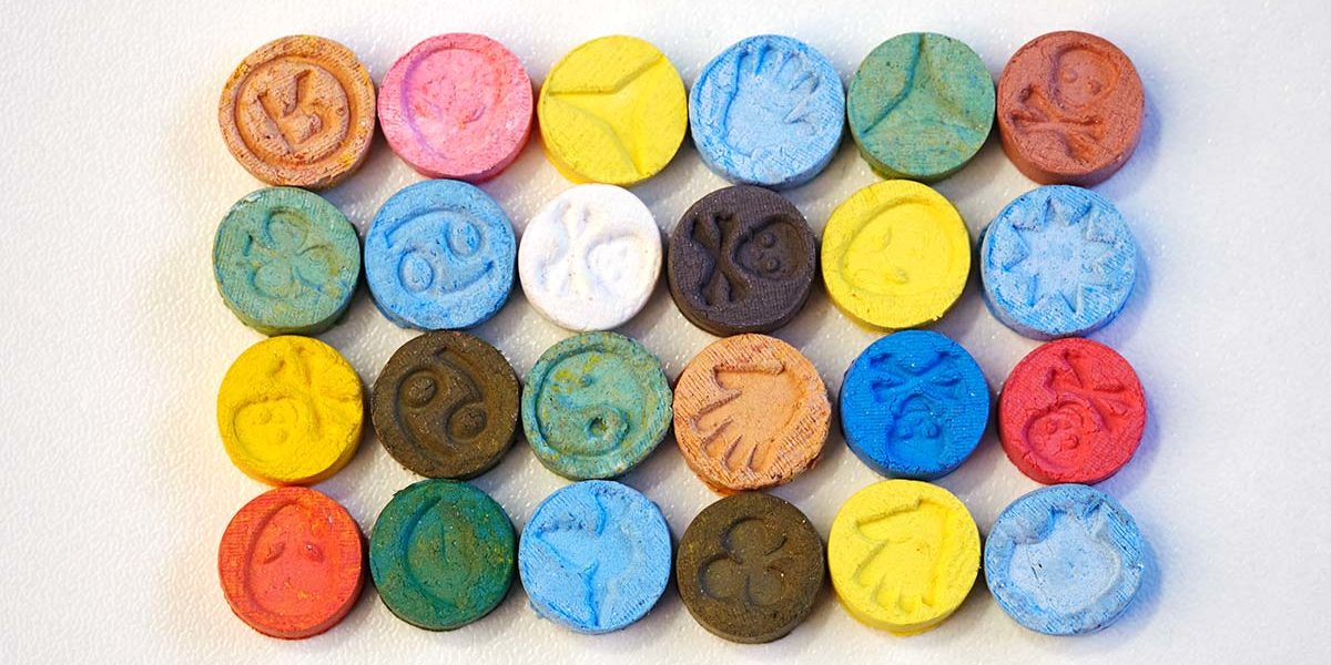 organized rows of multicolored ecstasy pills not allowed during ecstasy detox in florida