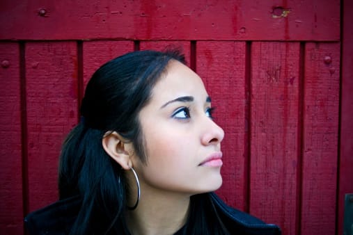 Woman on red background looking away from THC detox