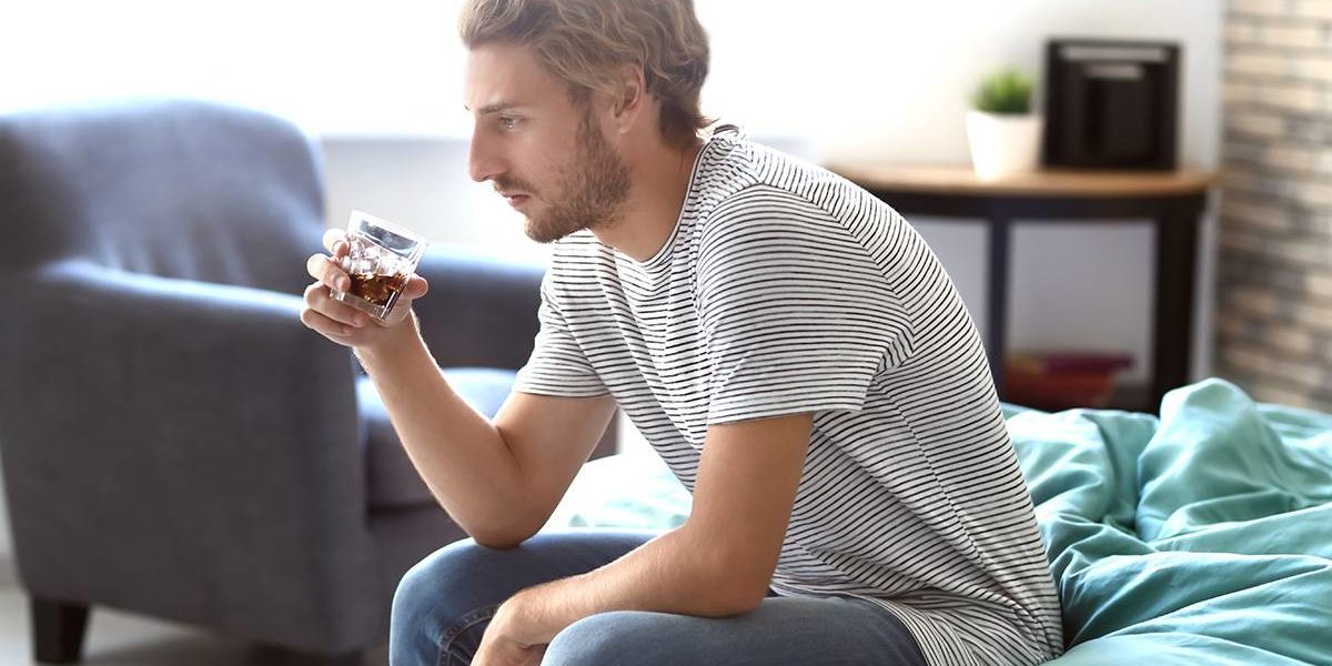 is alcohol a drug (3) man drinking glass of alcohol wondering is alcohol a drug