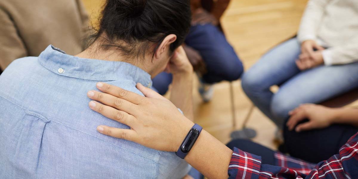 detox-center-in-florida person being comforted in the group circle at the detox center in florida