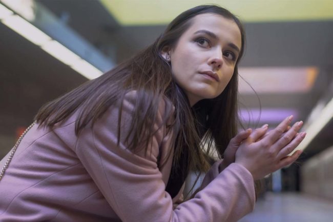 woman waiting for a train wondering, how does cocaine effect the brain