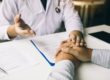 a man's hands on a table as he talks to his doctor about percocet detox in florida