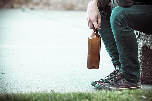 Person holding bottle by the water may need alcohol counseling as well as detox.