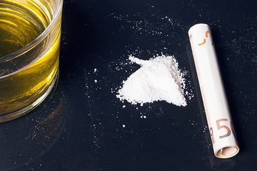 White powder and rolled up money are definite signs of cocaine addiction.