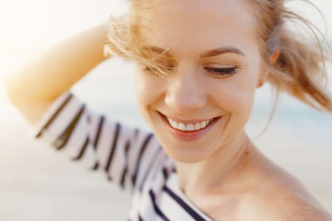 close up of smiling woman enjoying nature and the balance of medication and sobriety