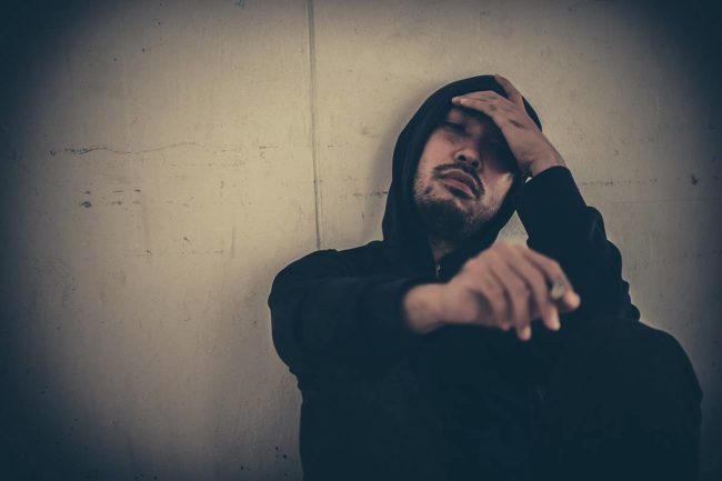 man struggles with the definite signs of heroin addiction