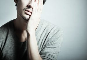 Tired and sad man experiencing amphetamine withdrawal symptoms