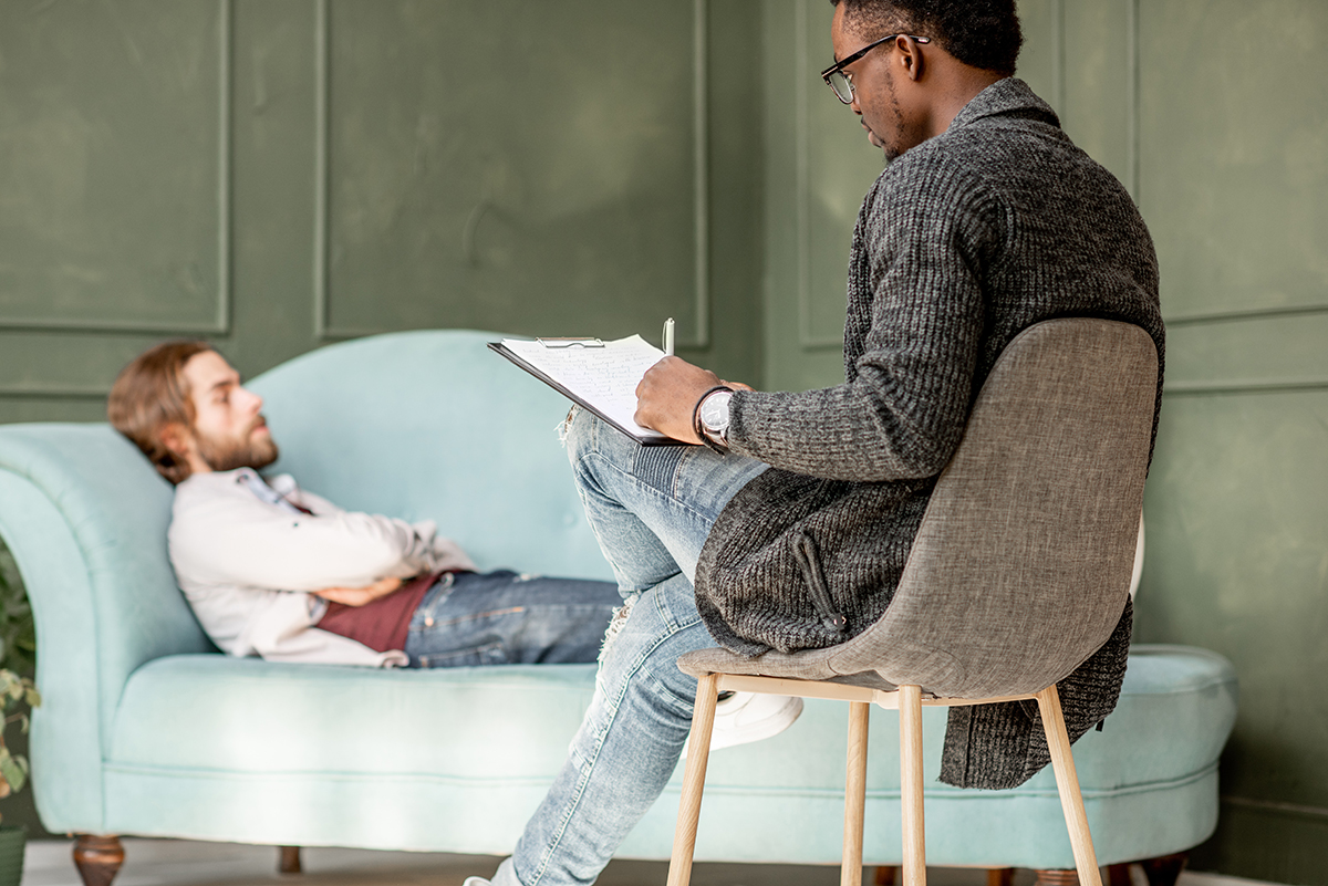 man laying on couch talking to therapist at medical detox centers in colorado
