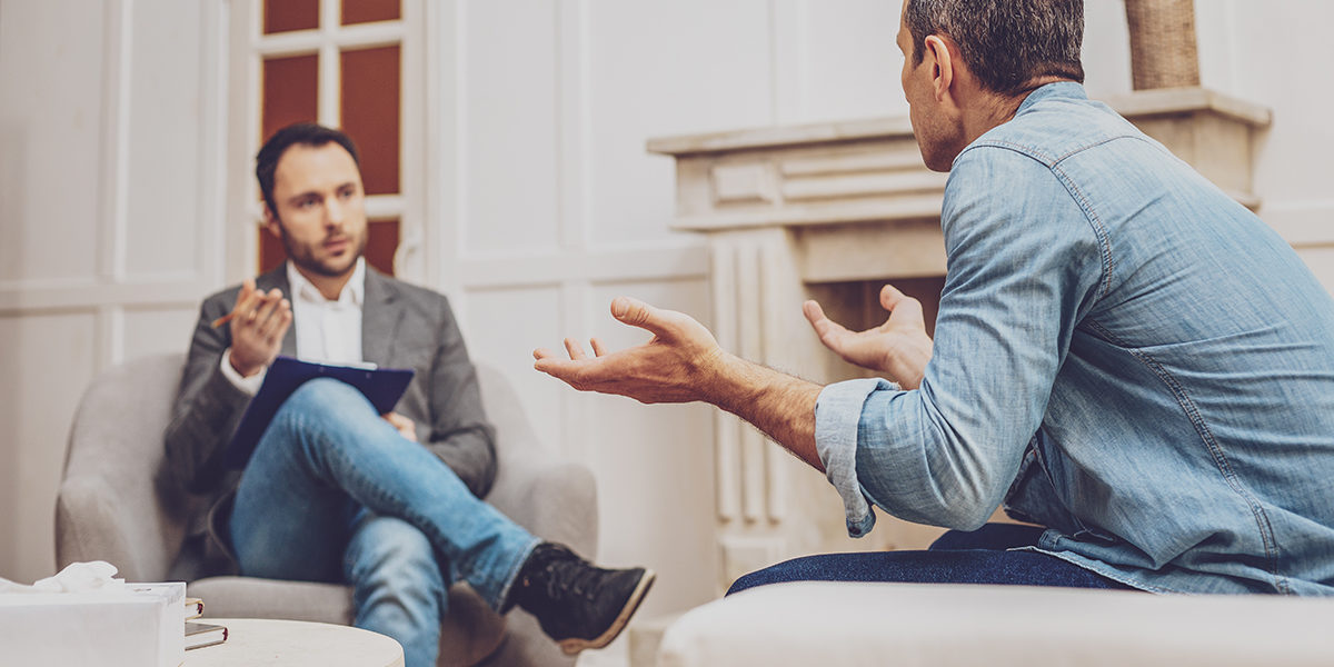 opiate detox in new jersey man talking to therapist at an opiate detox in new jersey