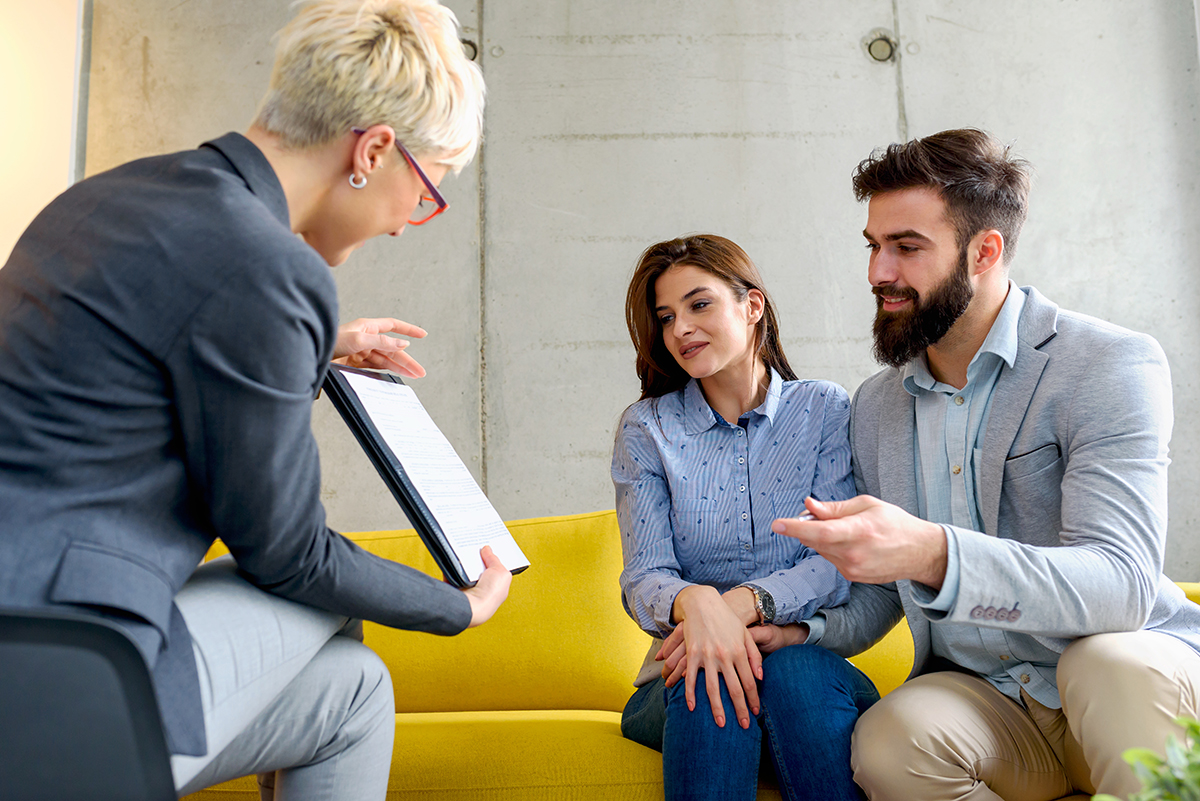 a couple discussing family therapy activities with a doctor