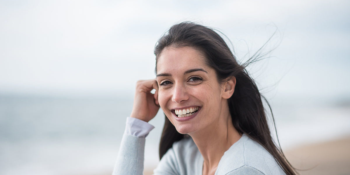 a woman smiling at outside of a west palm beach detox center
