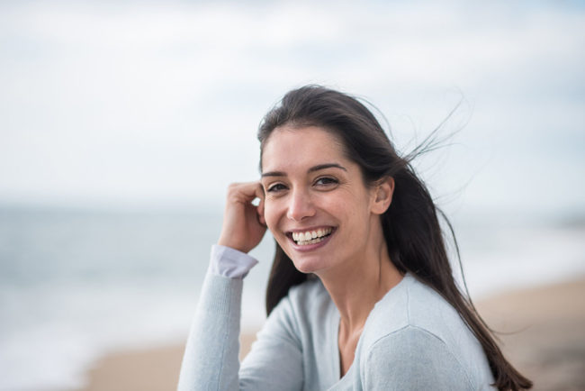 a woman smiling at outside of a west palm beach detox center