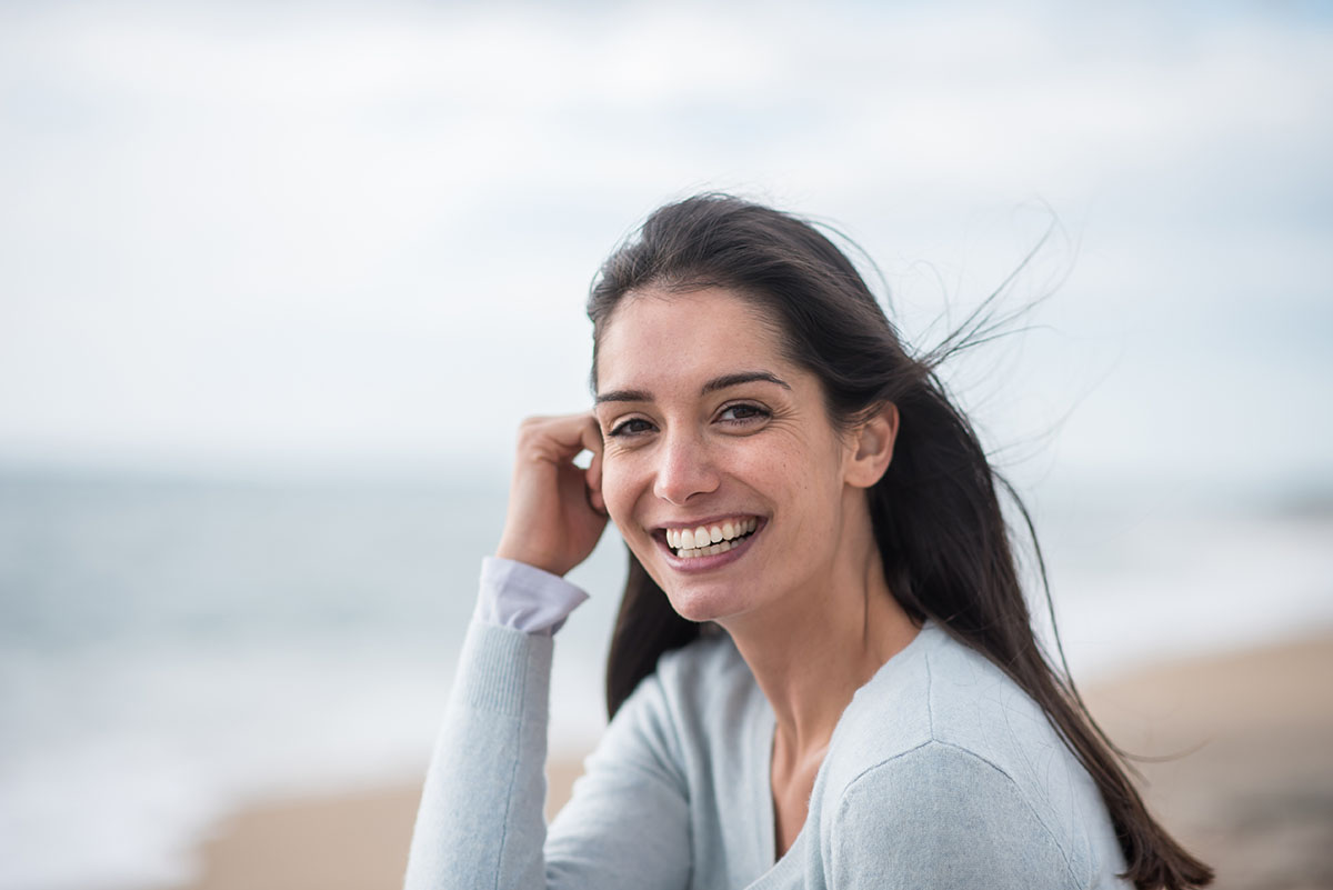 a woman smiling at outside of a west palm beach detox center