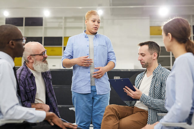 a group therapy session discussing alcohol addiction recovery