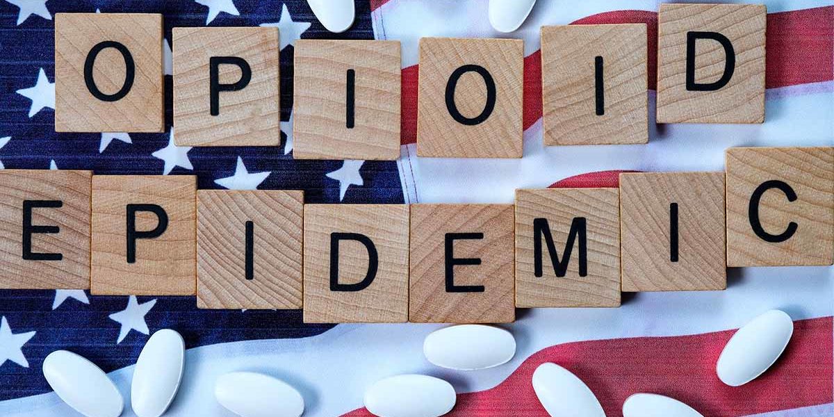 a flag and pills illustrating the opioid epidemic 2019