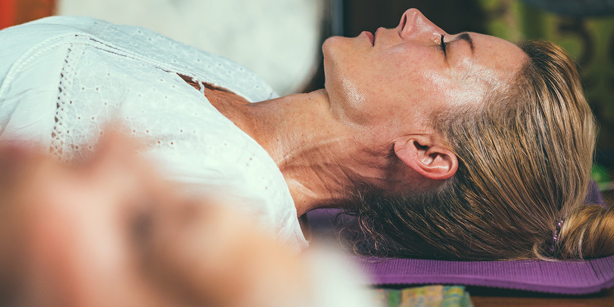 a woman meditating wondering how to find a detox facility