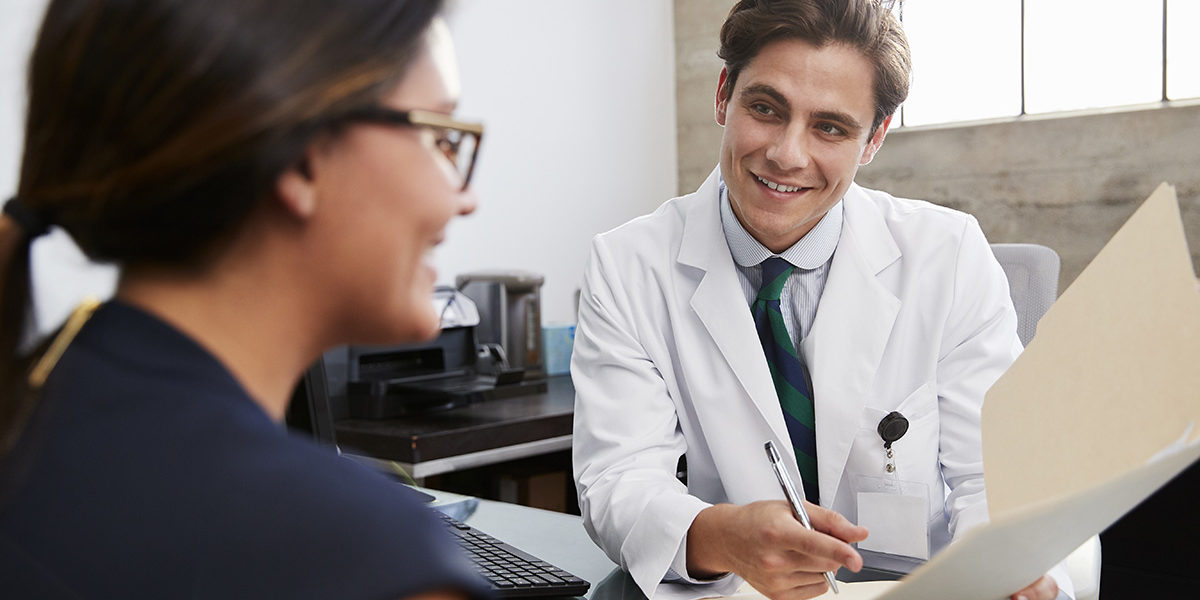 a doctor showing the family member of a patient their progress in a Montana drug detox