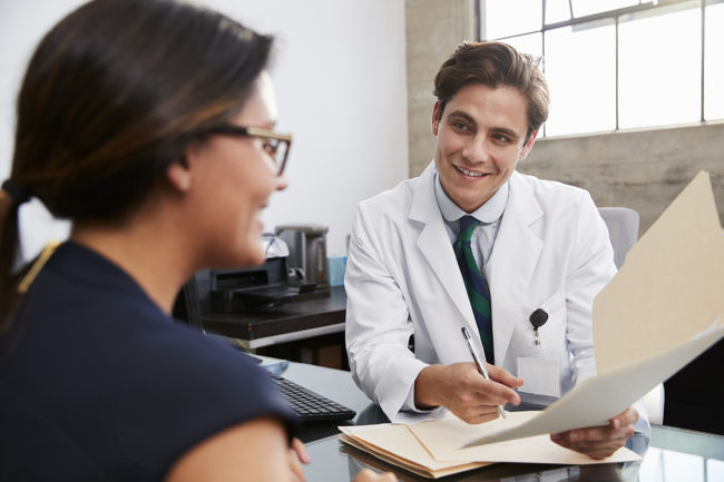 a doctor showing the family member of a patient their progress in a Montana drug detox