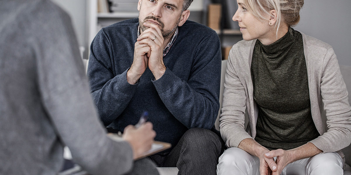 a couple discussing treatment options for a loved one at Serenity House Detox & Recovery