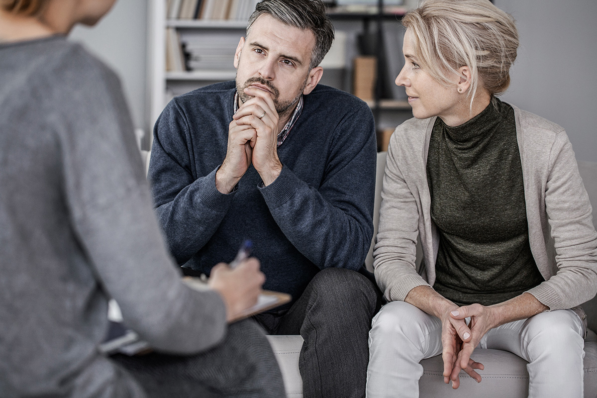 a couple discussing treatment options for a loved one at Serenity House Detox & Recovery