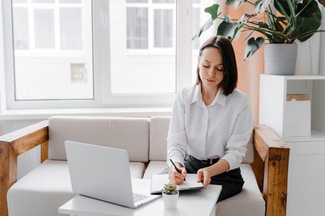 woman sitting and writing Wisconsin Detox