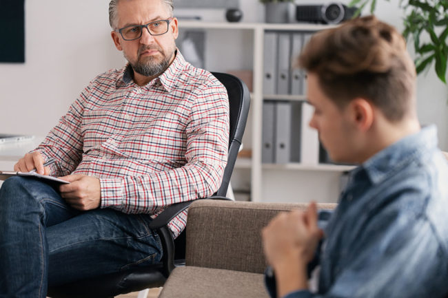 a doctor explaining to a patient the benefits of individual therapy