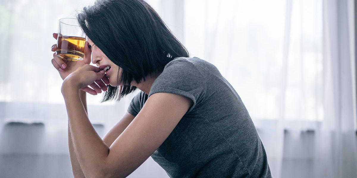 a woman drinking wondering how does alcoholism begin