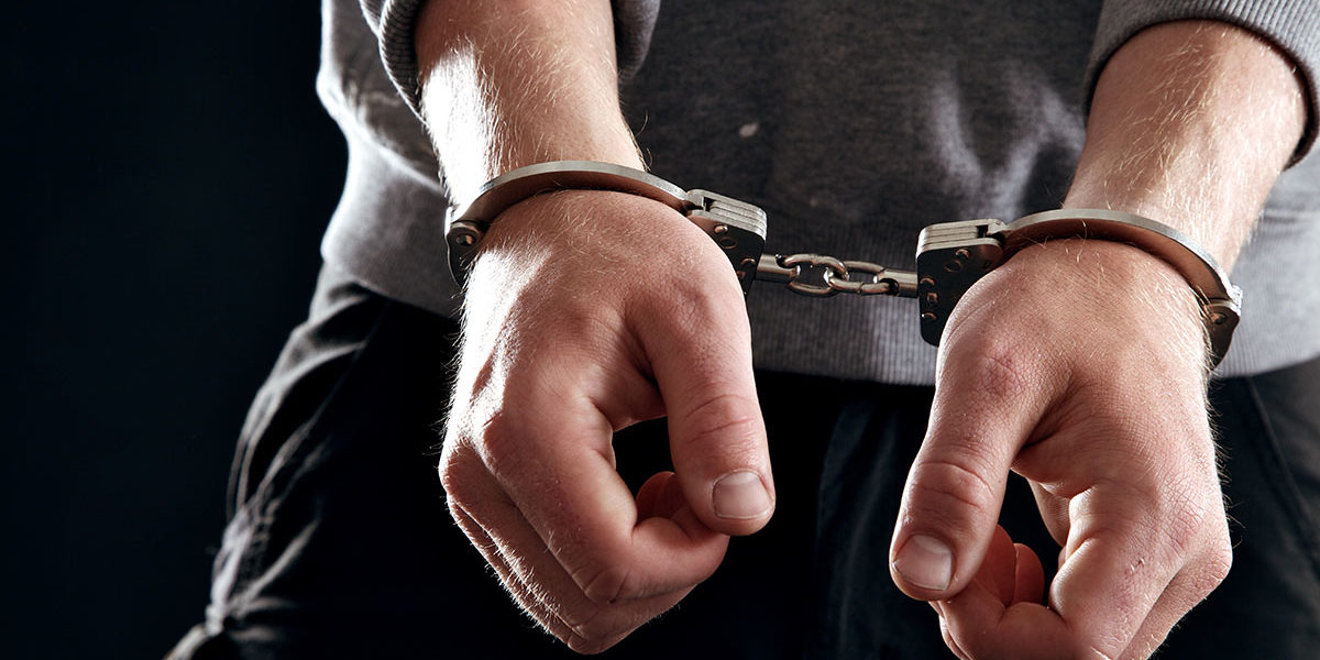 a man in handcuffs experiencing the legal consequences of cocaine
