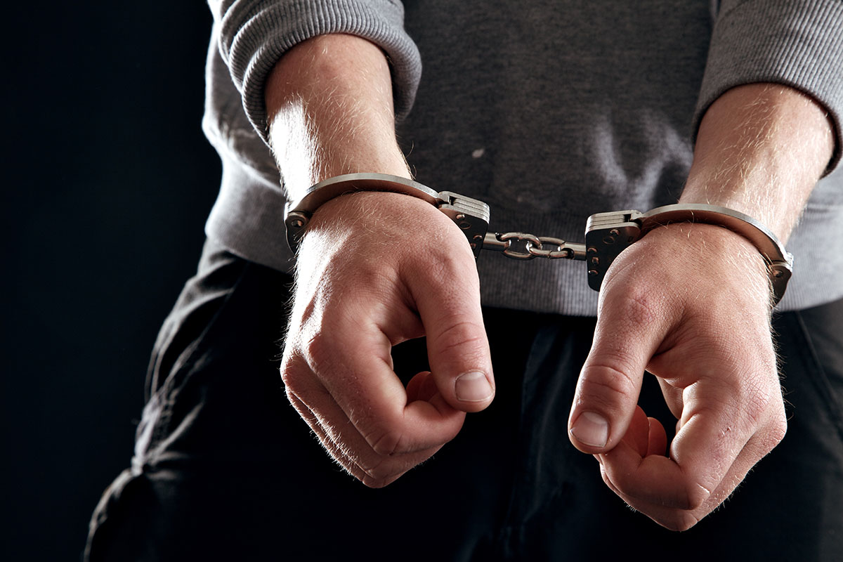 a man in handcuffs experiencing the legal consequences of cocaine