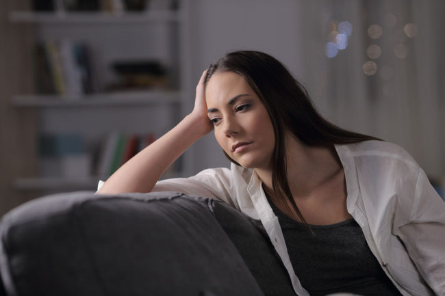 a woman thinking about the differences between physical dependence vs addiction