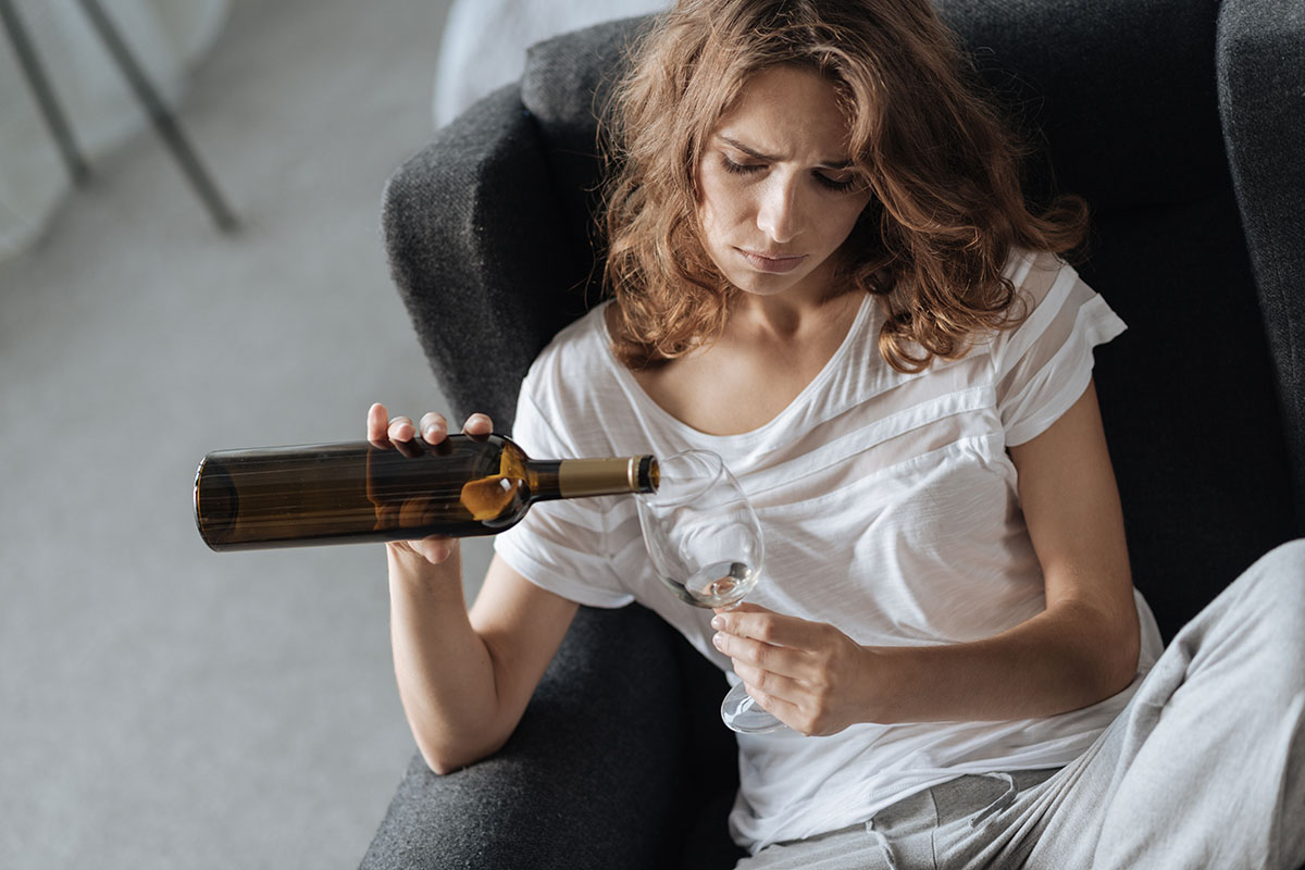 a depressed woman self medicating with alcohol