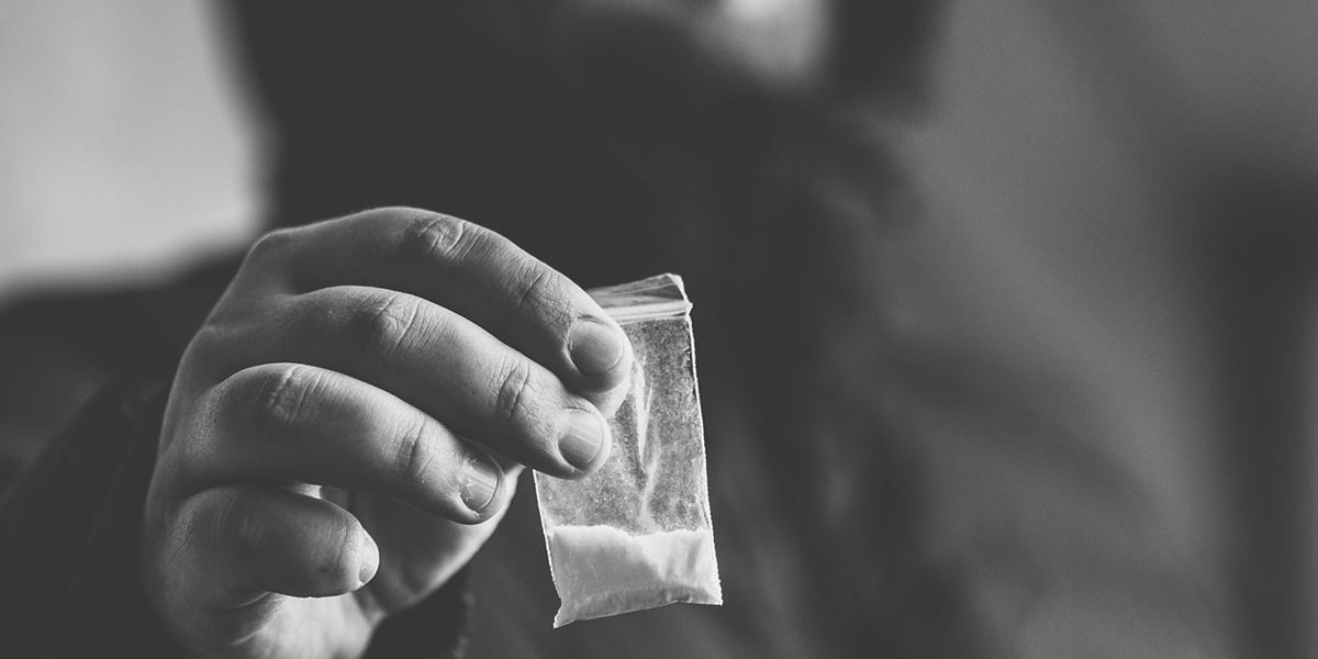 a man holding drugs no thinking about substance abuse vs addiction