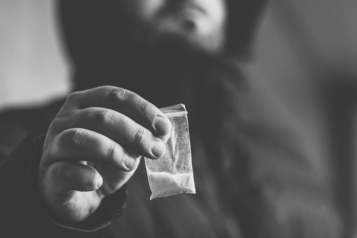 a man holding drugs no thinking about substance abuse vs addiction