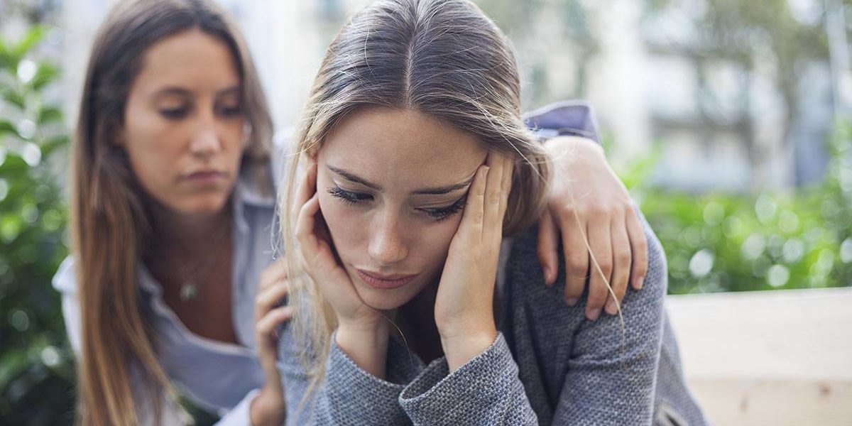 Woman consoles her addicted family member