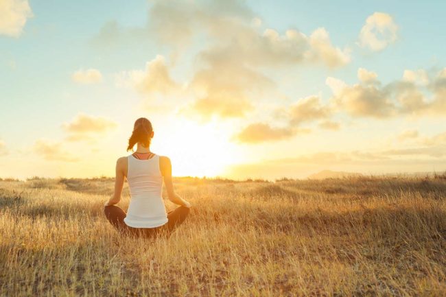 woman meditates to aid her addiction recovery