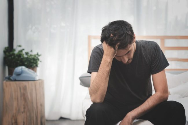 man deals with the common symptoms of taking crank